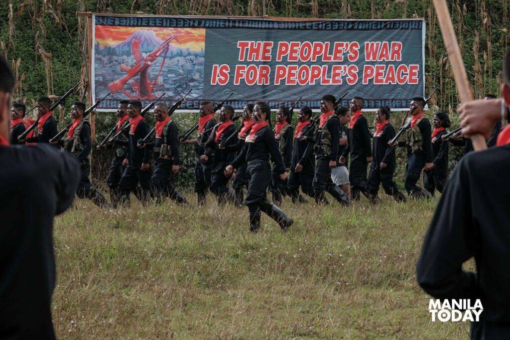 Around 200 NPA members marched in an open field and held a battalion formation. (Manila Today)