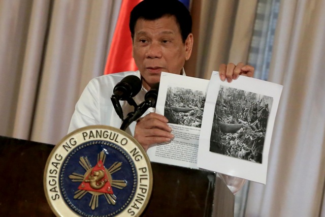President Rodrigo Duterte shows images of the Bud Dajo massacre during his speech at the 2016 Metrobank Foundation's Outstanding Filipinos awarding ceremony in Malacañan's Rizal Hall on September 12. PPD/Rey Baniquet